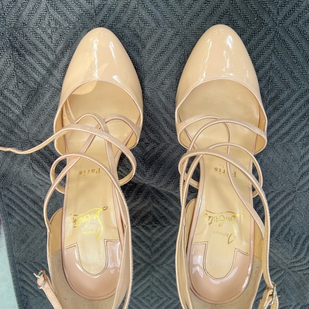 Christian Louboutin nude patent leather strappy heels.